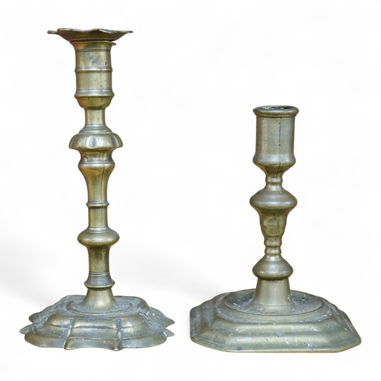 Two 18th century brass candlesticks, largest 23cm high